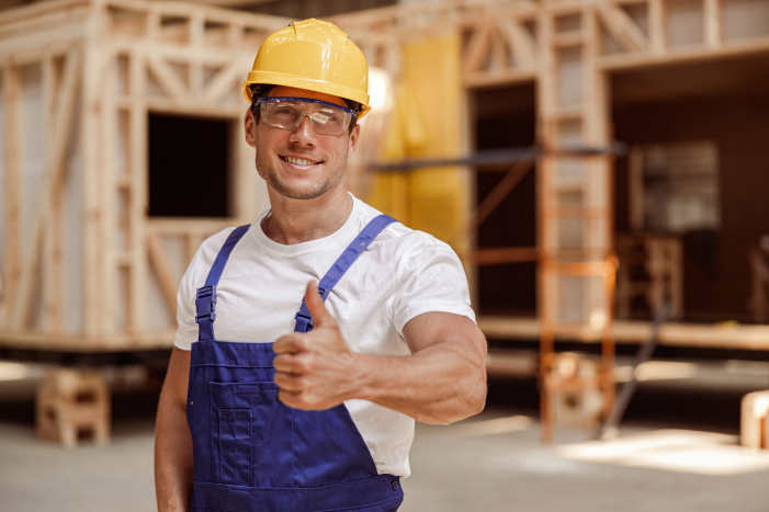 strong man smiling after getting the remodeling contractor insurance package
