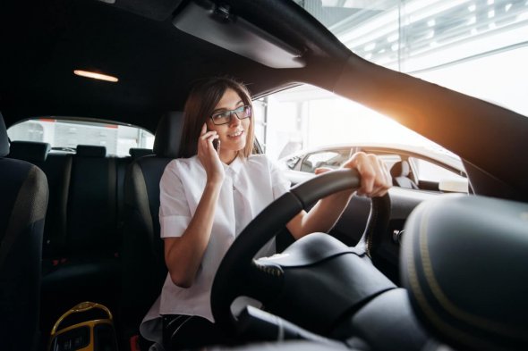 Businesswoman talking on the phone in the car